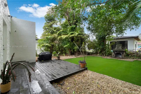 a view of a backyard with sitting area