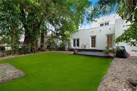 a view of a house with backyard sitting area and garden