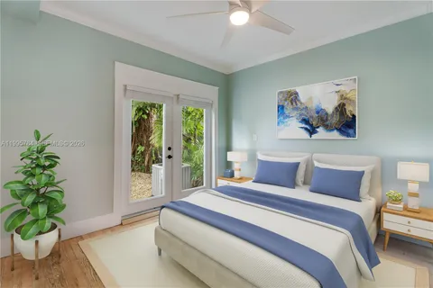 a bedroom with a large bed and a potted plant