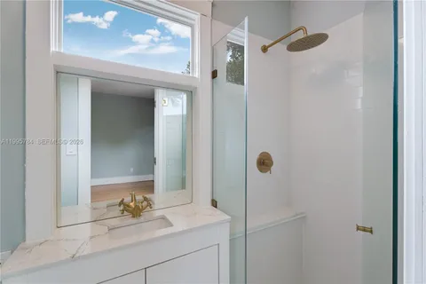 a bathroom with a sink vanity and mirror