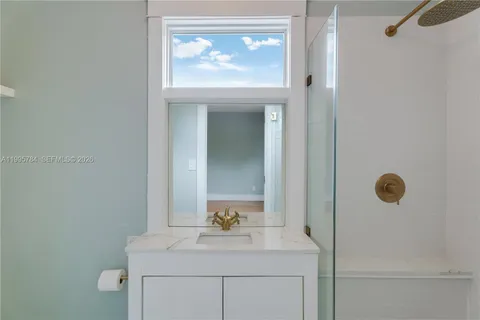 a bathroom with a sink a toilet and mirror
