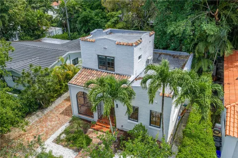 an aerial view of a house with a yard and potted plants