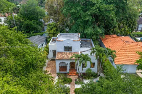 an aerial view of a house with balcony and garden