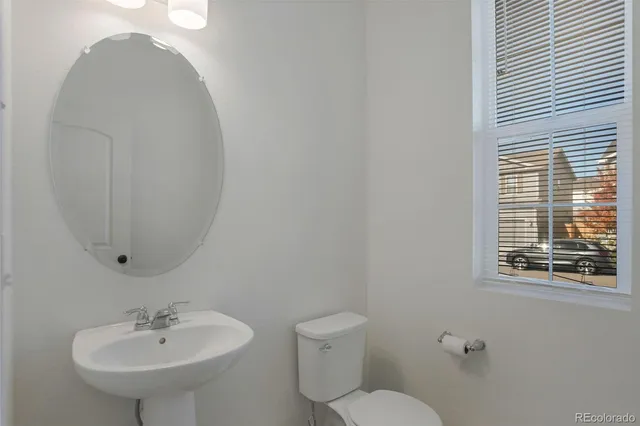 a bathroom with a sink a mirror and a toilet