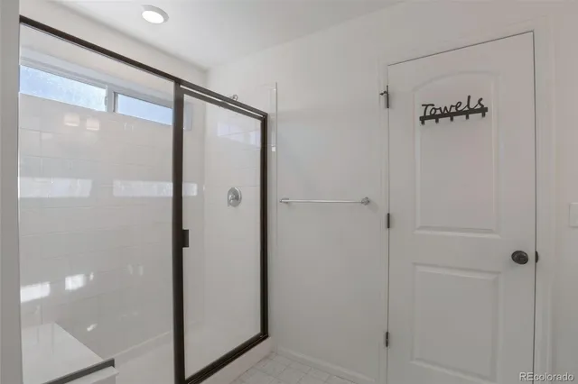 a bathroom with a glass shower door