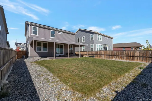 a view of a house with backyard and sitting area