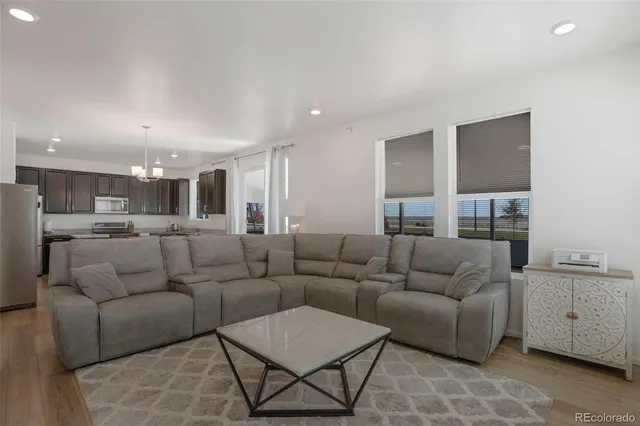 a living room with furniture and kitchen view
