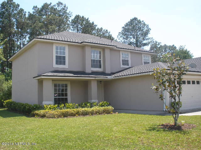 801 Crystal Spring Way St. Augustine, FL 32092 - Photo 1 of 15 a front view of a house with garden