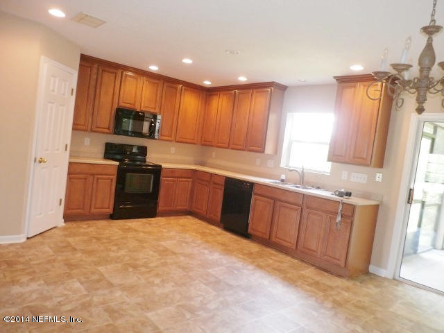 801 Crystal Spring Way St. Augustine, FL 32092 - Photo 12 of 15 a large kitchen with cabinets