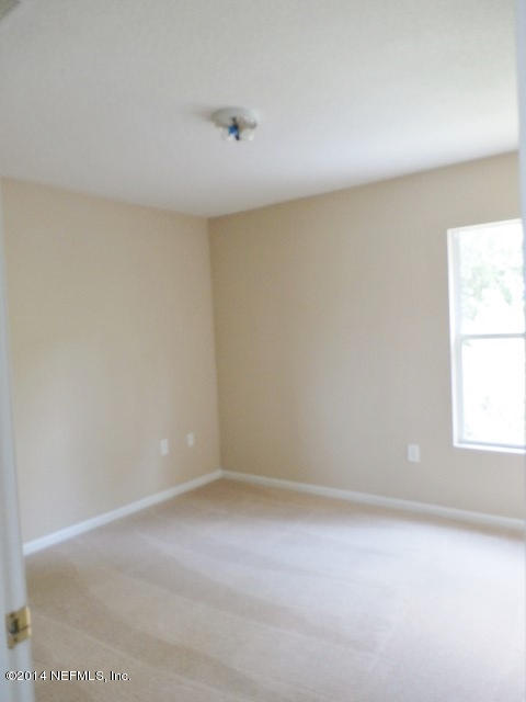 801 Crystal Spring Way St. Augustine, FL 32092 - Photo 2 of 15 an empty room with a window