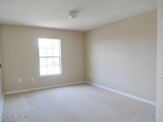 801 Crystal Spring Way St. Augustine, FL 32092 - Photo 3 of 15 an empty room with a window