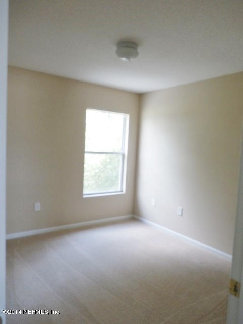801 Crystal Spring Way St. Augustine, FL 32092 - Photo 4 of 15 an empty room with a window