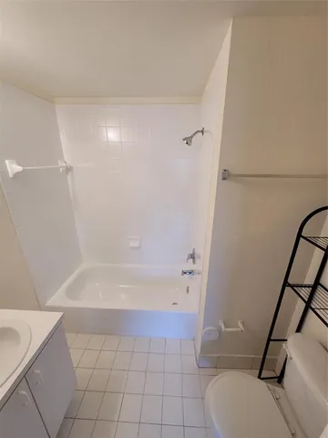 a bathroom with a bathtub and toilet