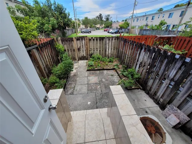 a view of a street with wooden fence