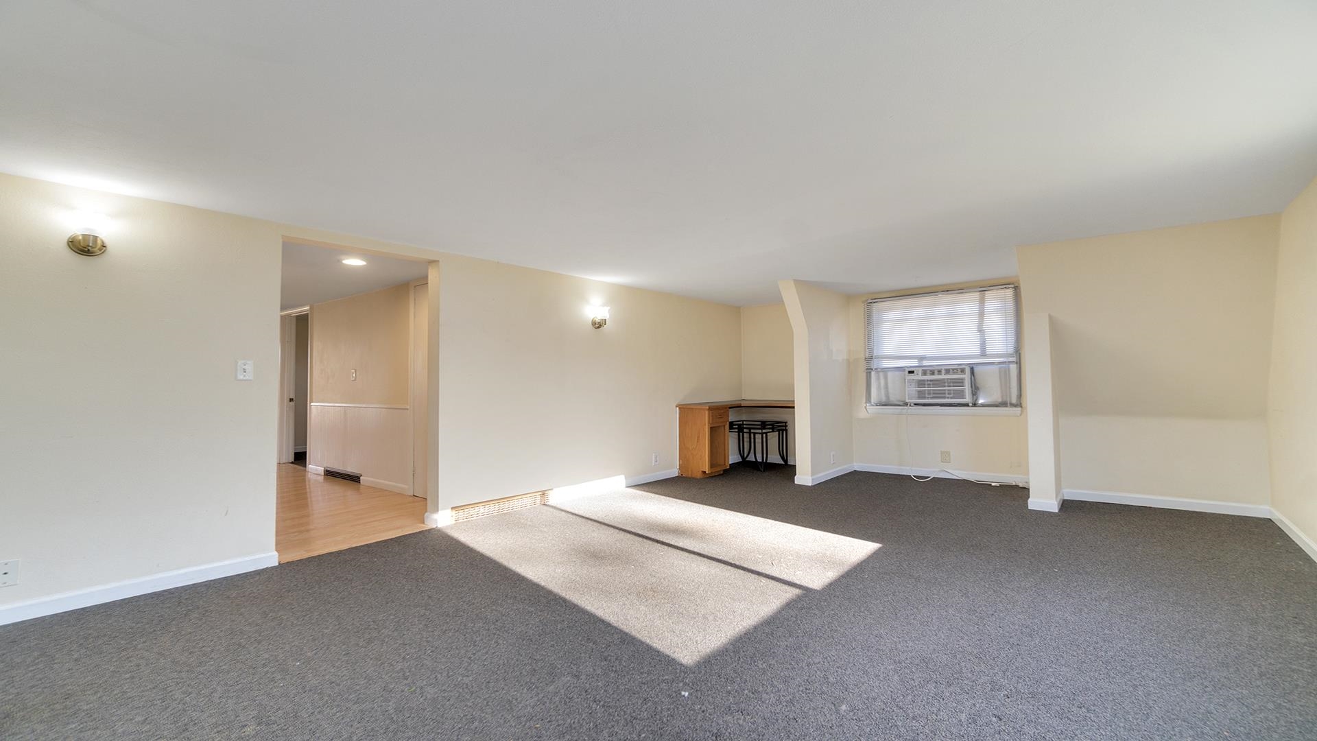 3702 Genoa Road Cherry Valley, IL 61016 - Photo 6 of 17 an empty room with fireplace and windows