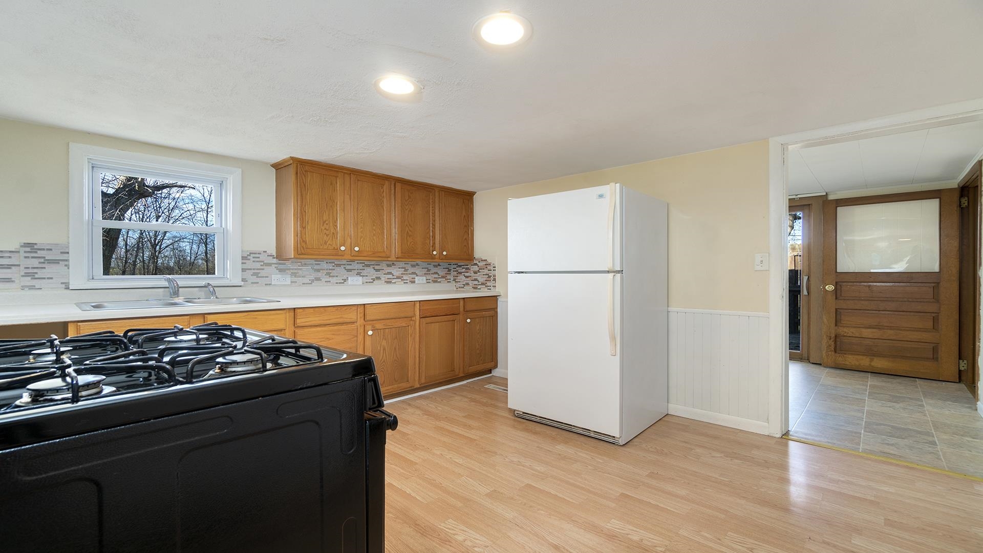 3702 Genoa Road Cherry Valley, IL 61016 - Photo 7 of 17 a kitchen with granite countertop a stove and a refrigerator