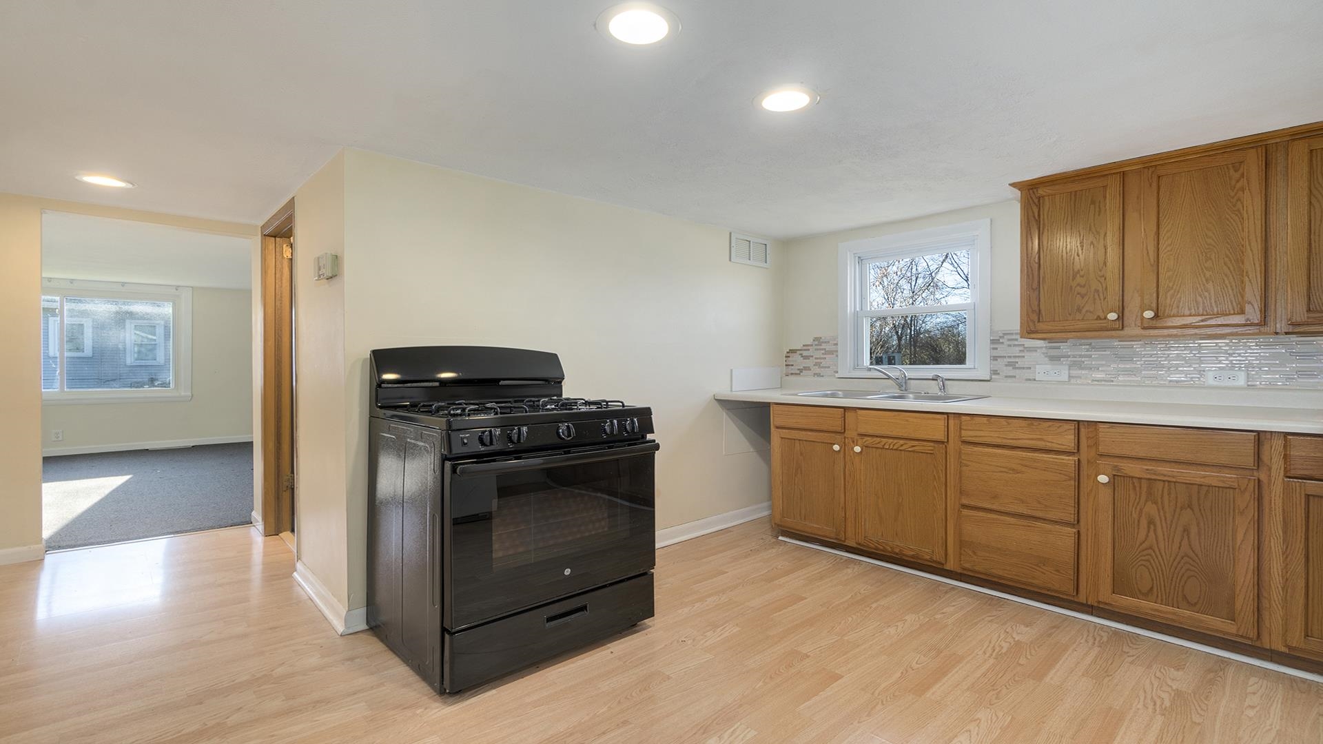 3702 Genoa Road Cherry Valley, IL 61016 - Photo 8 of 17 a kitchen with granite countertop a stove and a sink