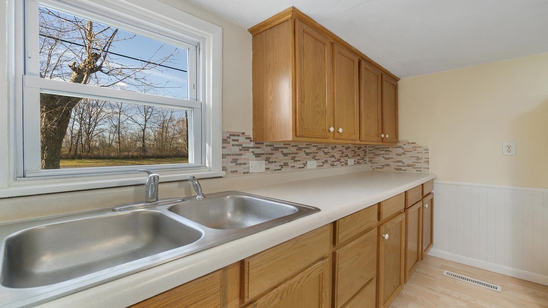 3702 Genoa Road Cherry Valley, IL 61016 - Photo 9 of 17 a kitchen with a sink and cabinets