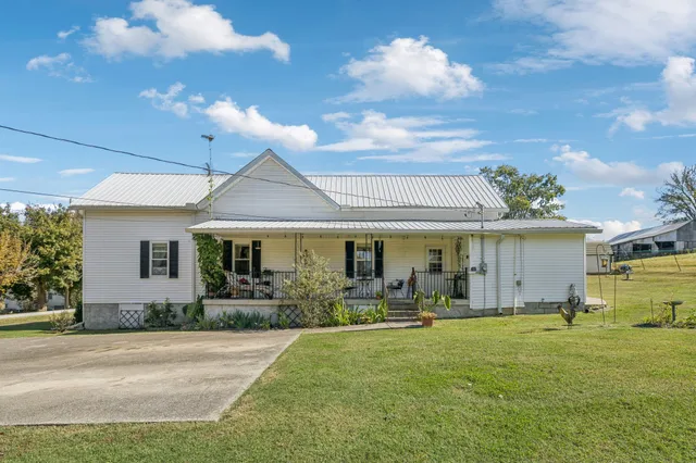 a backyard of a house with table and chairs