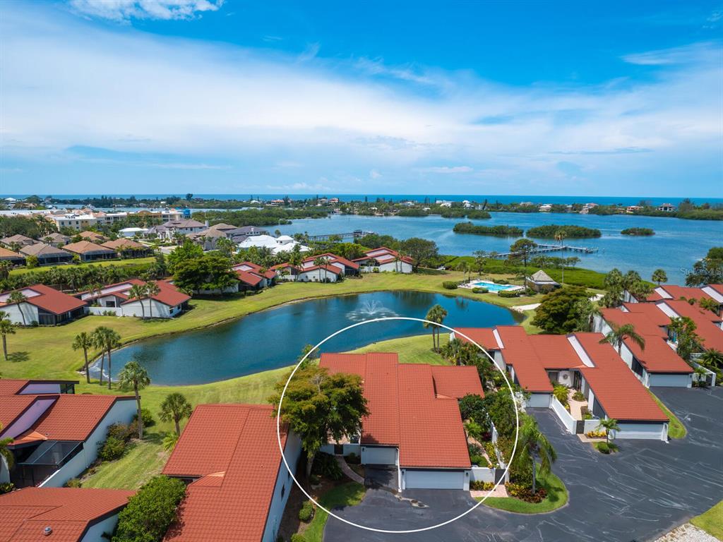 784 Sarabay Road, Unit 18 Osprey, FL 34229 - Photo 1 of 1 an aerial view of residential houses with outdoor space and lake view
