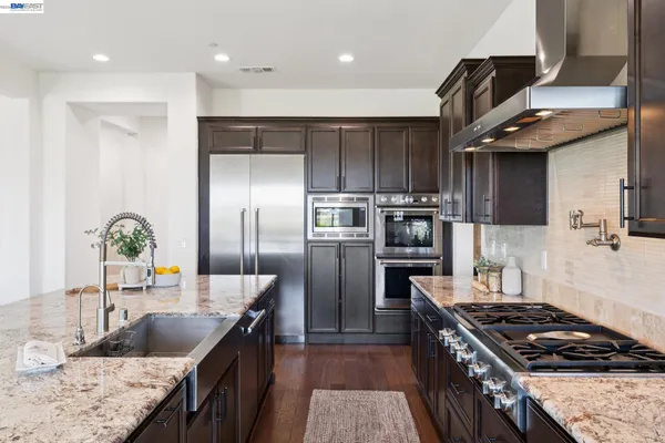 a kitchen with a sink and a refrigerator