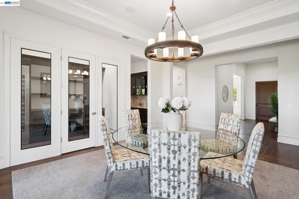 a view of a dining room with furniture and chandelier