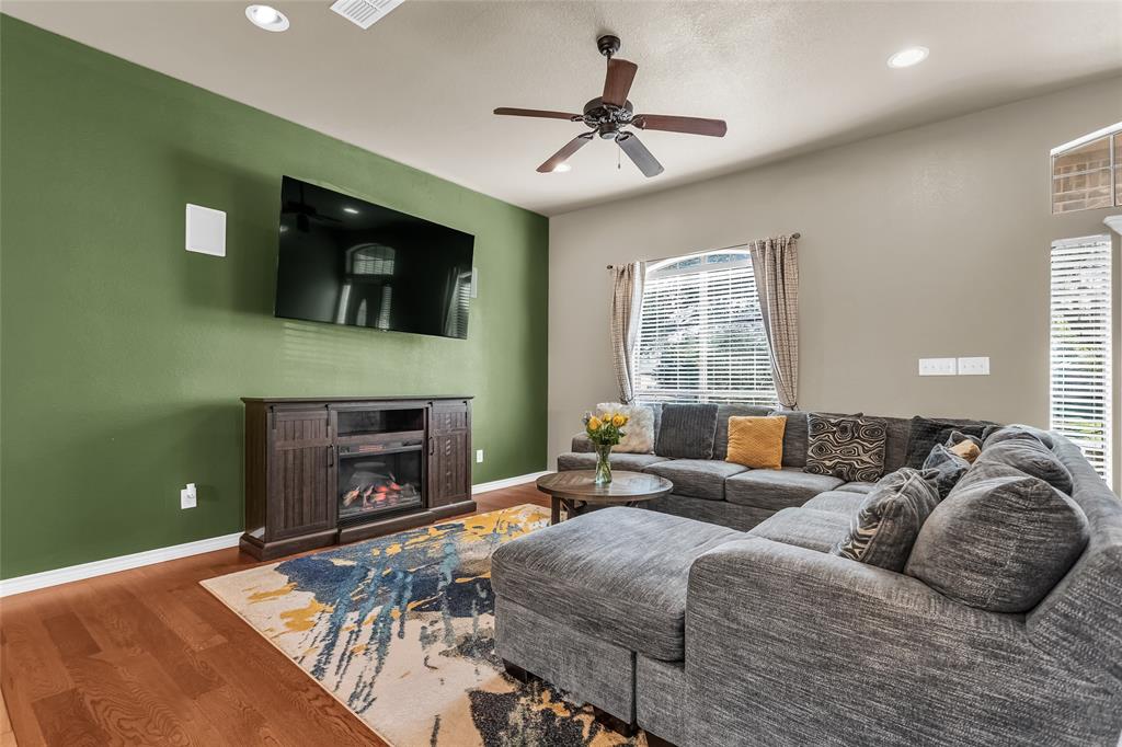 226 King George Road Ponder, TX 76259 - Photo 14 of 39 a spacious bedroom with a bed a fireplace and windows