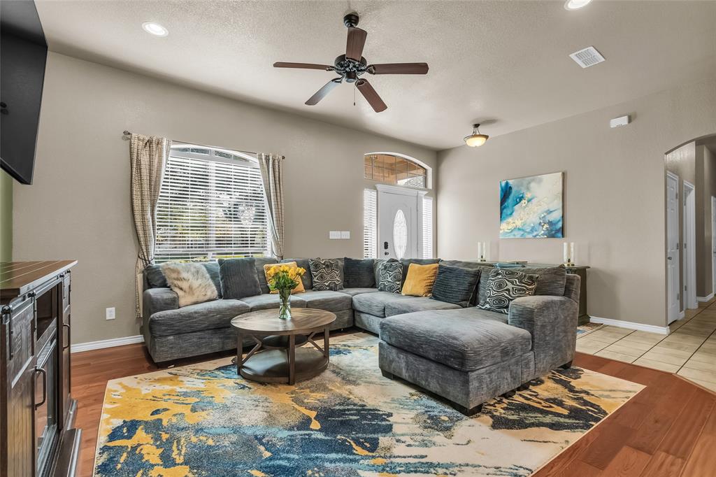 226 King George Road Ponder, TX 76259 - Photo 18 of 39 Living room featuring arched walkways, recessed lighting, lofted ceiling, a chandelier, and ceiling fan