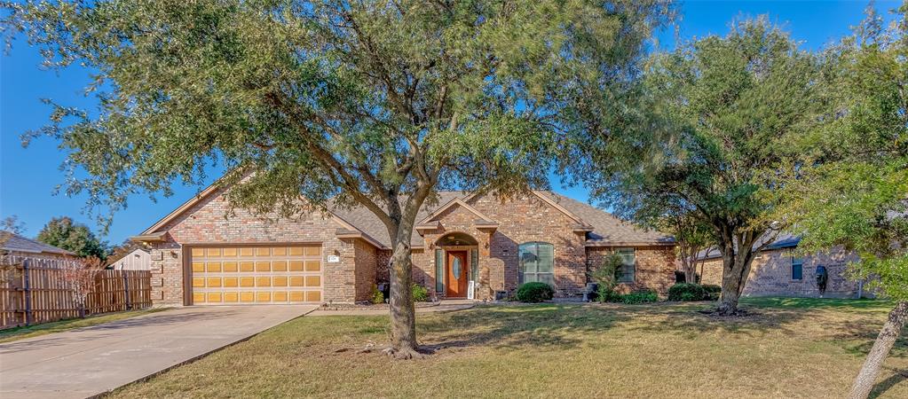 226 King George Road Ponder, TX 76259 - Photo 2 of 39 Traditional home featuring driveway, brick siding, a garage, and a shingled roof