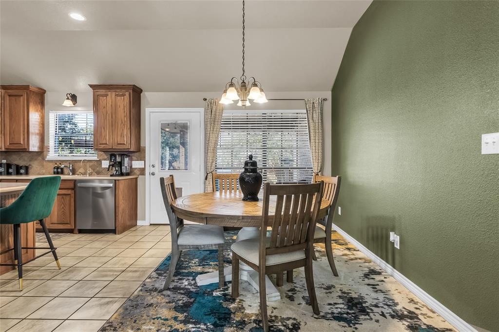 226 King George Road Ponder, TX 76259 - Photo 20 of 39 Dining space with a chandelier, light tile patterned floors, a textured wall, and lofted ceiling