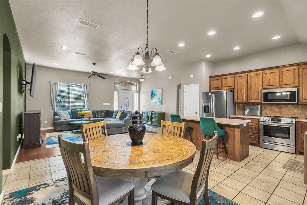 226 King George Road Ponder, TX 76259 - Photo 21 of 39 Dining area featuring a chandelier, light tile patterned flooring, recessed lighting, ceiling fan, and arched walkways