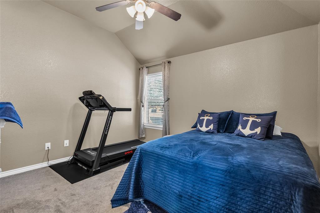 226 King George Road Ponder, TX 76259 - Photo 33 of 39 Bedroom featuring vaulted ceiling, a textured wall, carpet flooring, and a ceiling fan