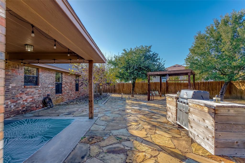 226 King George Road Ponder, TX 76259 - Photo 10 of 39 Fenced backyard featuring a patio area and an outdoor kitchen