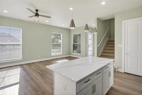 a kitchen with a stove a sink and a refrigerator