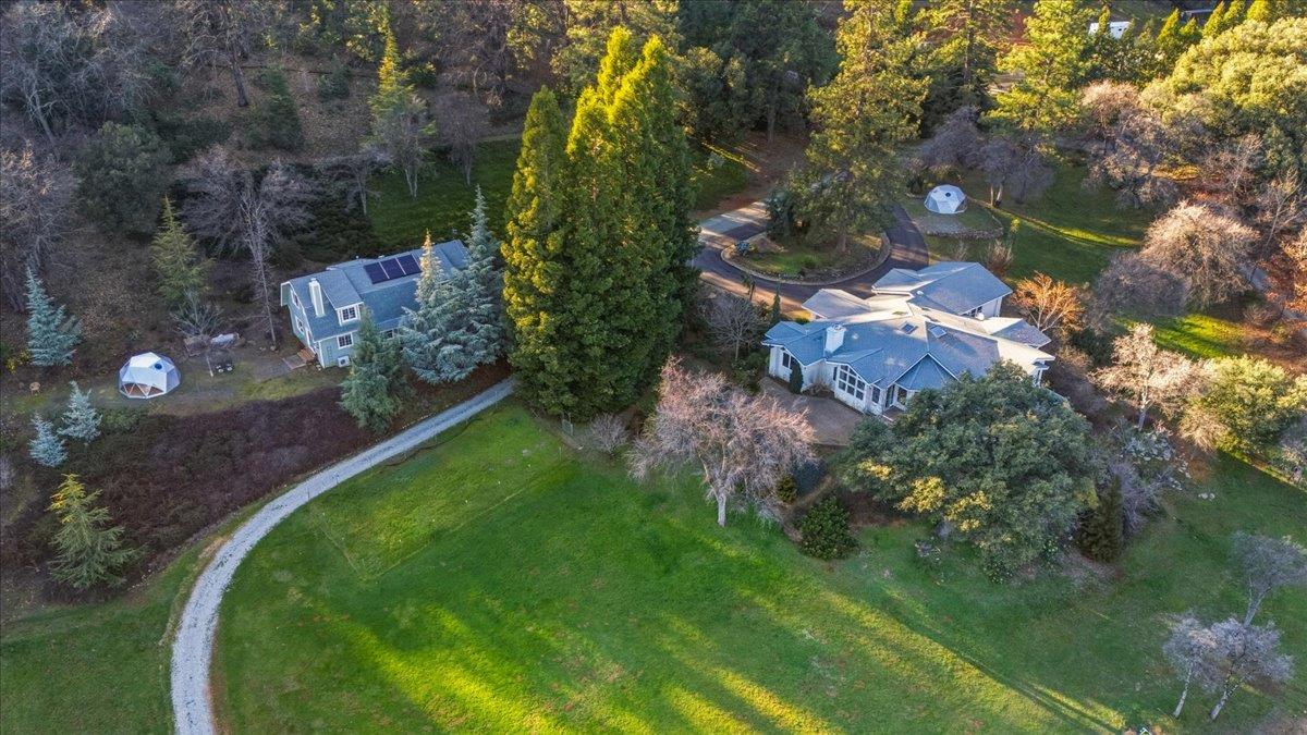 14771 Mt Olive Road Grass Valley, CA 95945 - Photo 3 of 96 Main Home, ADU, Geodomes, Yurt, Tractor Shed, Wood Shed, pond, dock, owned solar, orchard...all with privacy, views and functionality in mind! This is a special space.