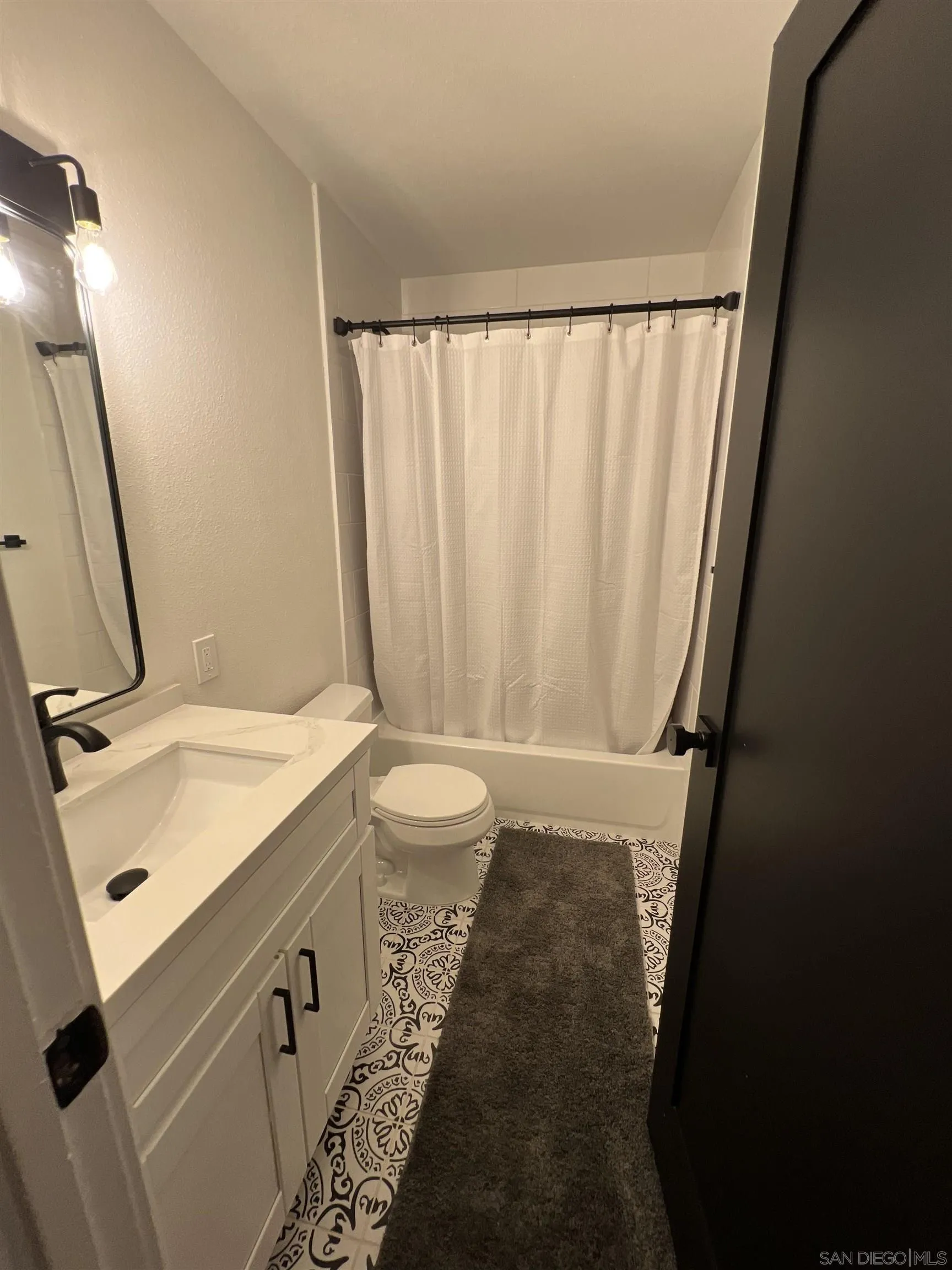 5462 Adobe Falls Road, Unit 11 San Diego, CA 92120 - Photo 15 of 19 a bathroom with a sink and a mirror