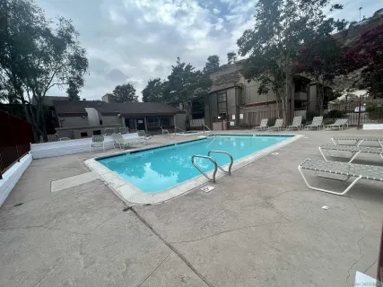a view of a swimming pool with a patio