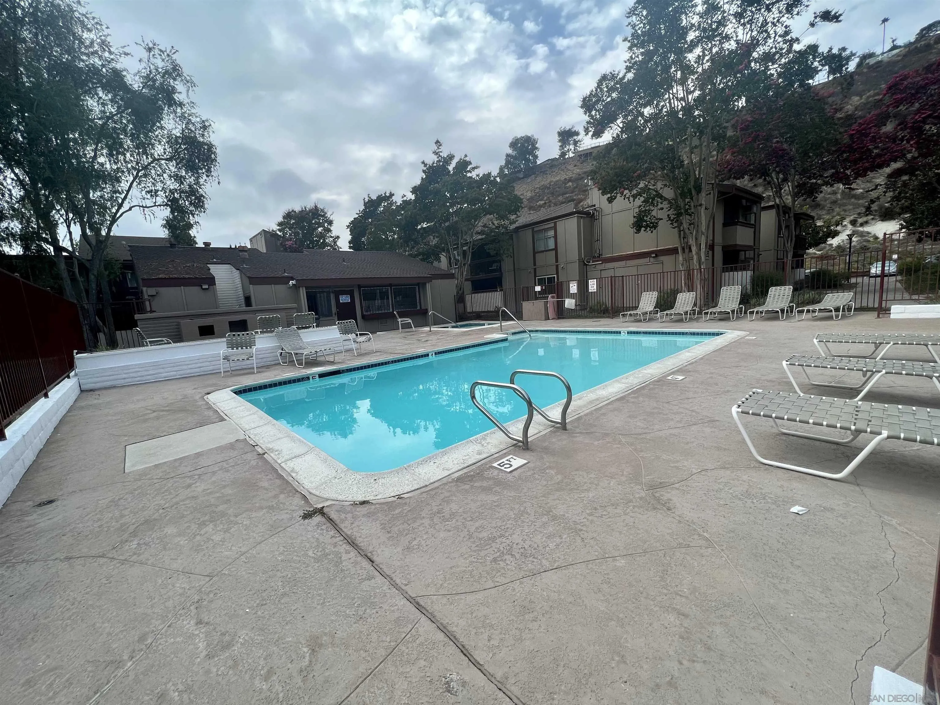 5462 Adobe Falls Road, Unit 11 San Diego, CA 92120 - Photo 18 of 19 a view of a swimming pool with a patio