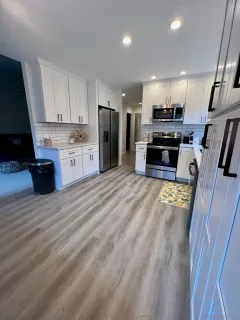 a large kitchen with stainless steel appliances kitchen island granite countertop a refrigerator sink and stove