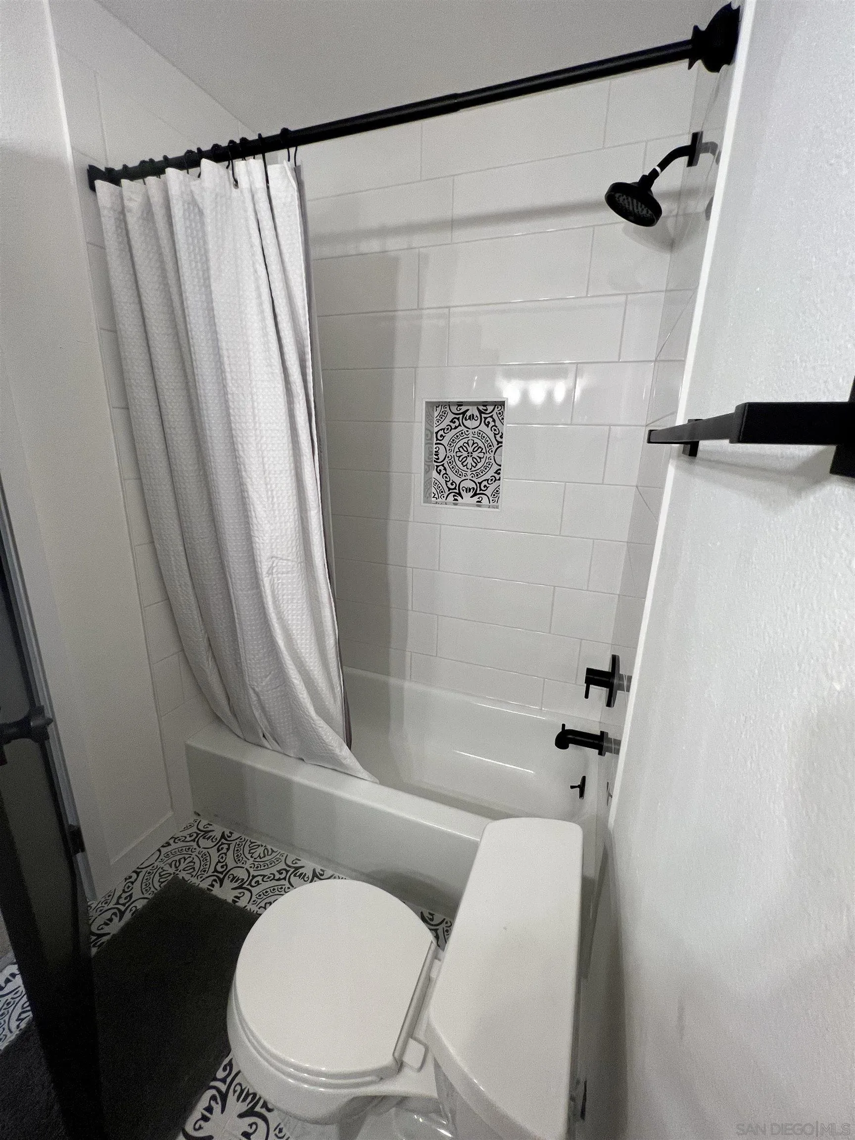 5462 Adobe Falls Road, Unit 11 San Diego, CA 92120 - Photo 6 of 19 a white toilet sitting next to a bath tub