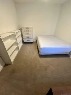 a bedroom with a bed and cupboard
