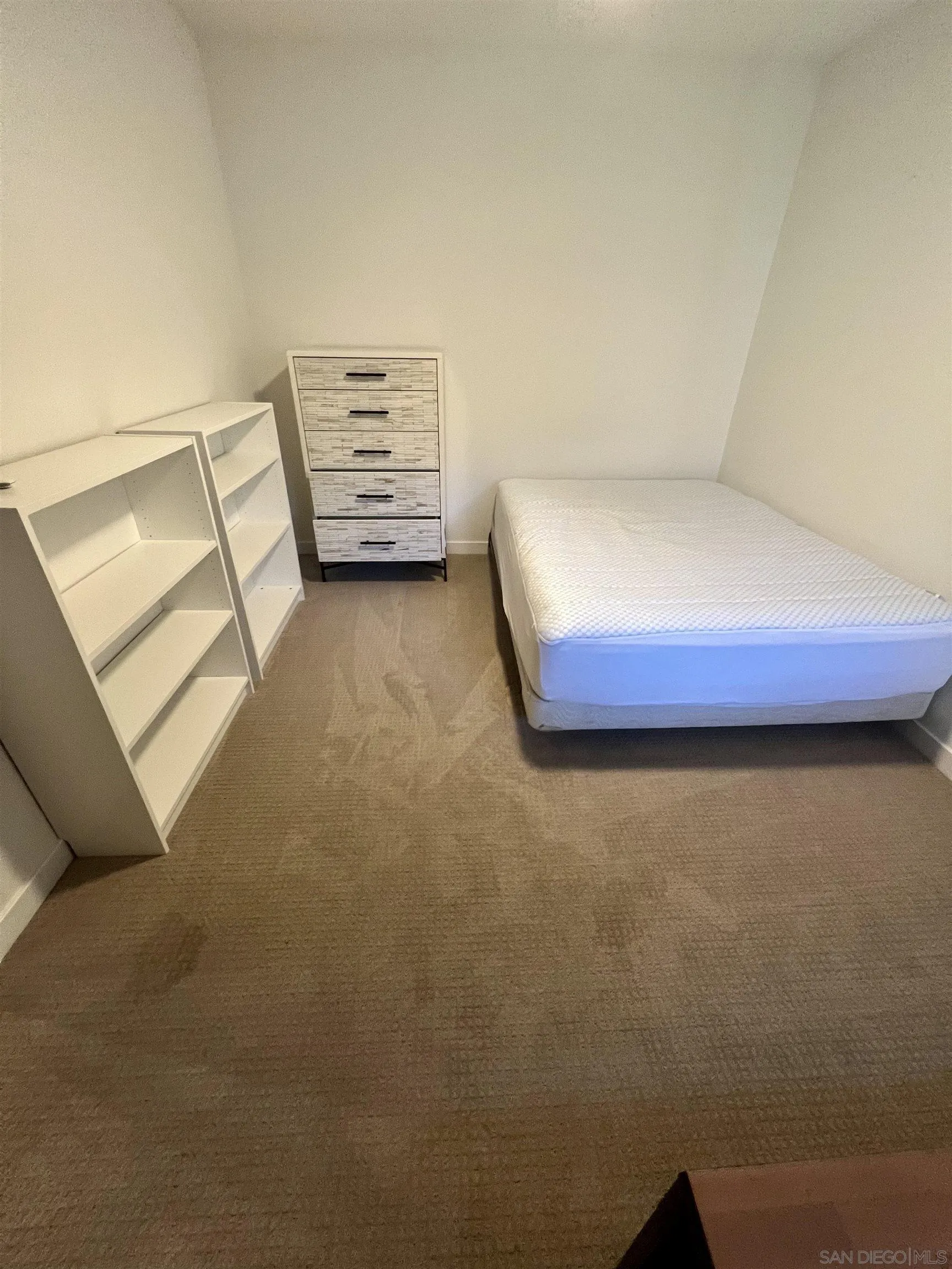 5462 Adobe Falls Road, Unit 11 San Diego, CA 92120 - Photo 8 of 19 a bedroom with a bed and cupboard
