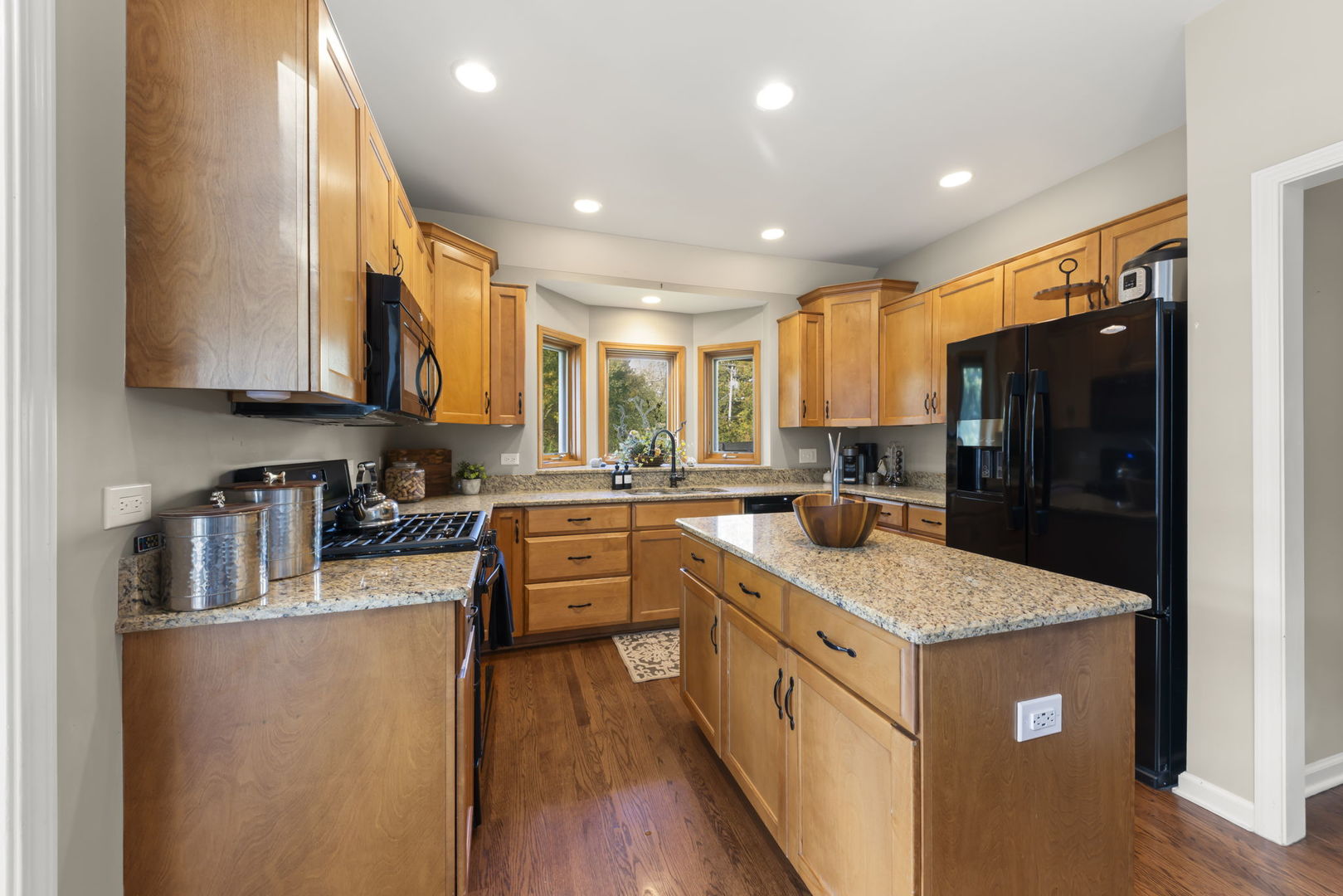 N436 Willow Road Wheaton, IL 60187 - Photo 9 of 34 a kitchen with stainless steel appliances granite countertop a sink stove and refrigerator