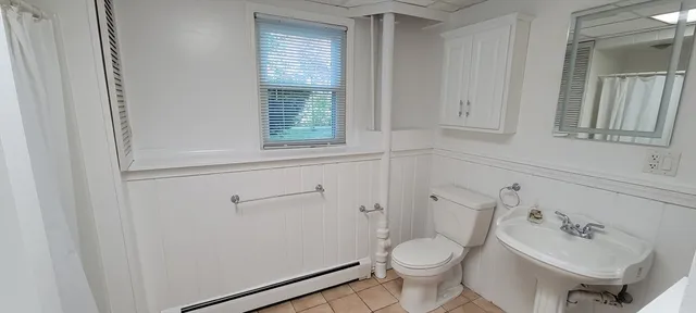 a white toilet sitting next to a bathroom sink