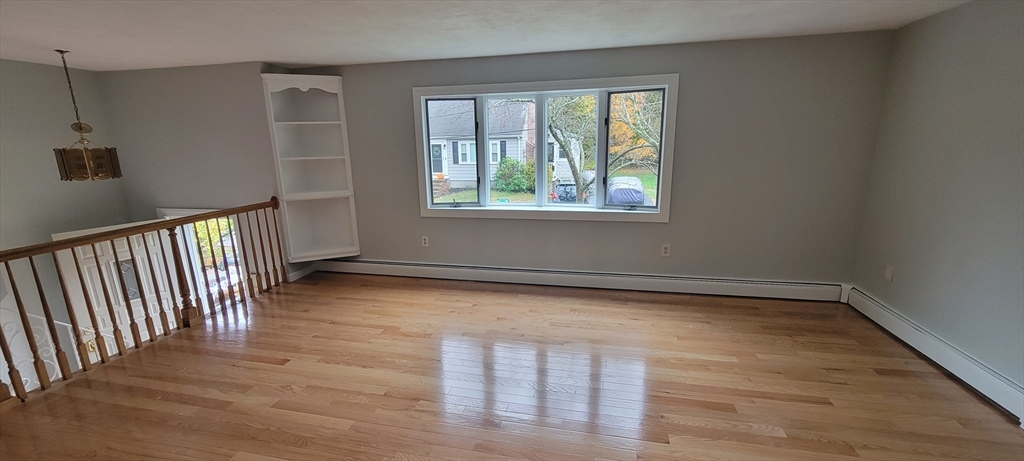 35 Park Avenue Reading, MA 01867 - Photo 3 of 15 wooden floor in an empty room with a window