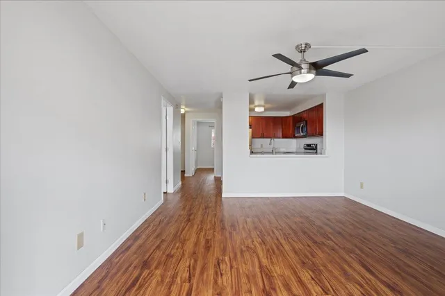 a view of a big room with wooden floor and closet area