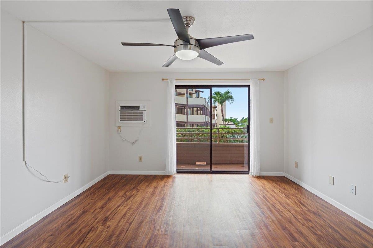2747 South Kihei Road, Unit A107 Kihei, HI 96753 - Photo 17 of 46 an empty room with wooden floor and windows