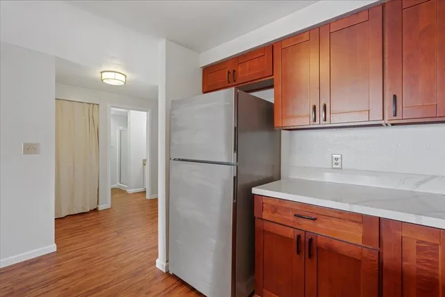 a kitchen with stainless steel appliances granite countertop a refrigerator and a sink