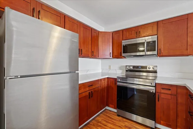 a kitchen with a refrigerator sink and microwave