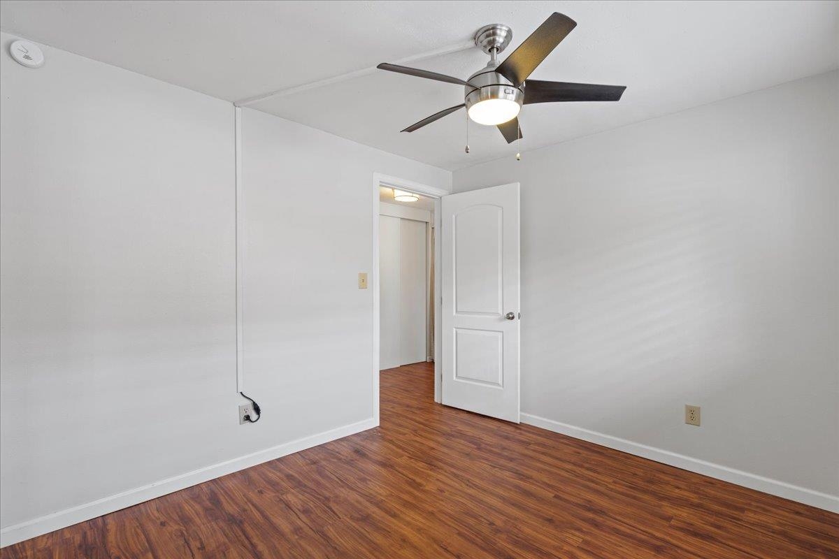 2747 South Kihei Road, Unit A107 Kihei, HI 96753 - Photo 24 of 46 an empty room with wooden floor fan and windows